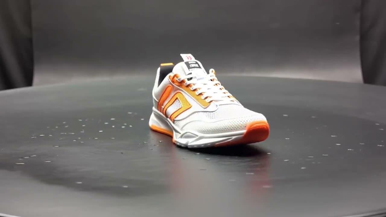 Product shot: a white and orange running sneaker rotating slowly on a black surface, rim light, water droplets on the mesh, studio.